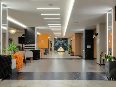 a lobby of a hotel with a table and chairs at SPA Hotel Olymp in Velingrad