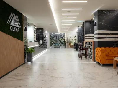 a lobby of a store with chairs and tables at SPA Hotel Olymp in Velingrad
