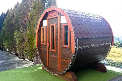 a small wooden house on display in a field at SPA Hotel Olymp in Velingrad