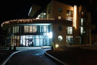 a large building at night with lights on it at Evridika Hotel in Devin