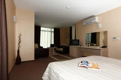 a hotel room with a bed and a living room at Evridika Hotel in Devin
