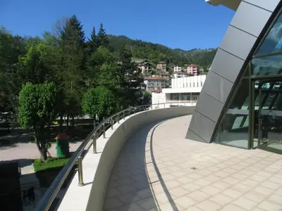 a bridge over a walkway next to a building at Evridika Hotel in Devin