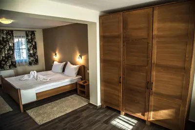 a bedroom with a bed and a closet at Red House in Koprivshtitsa