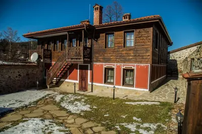 a house with a staircase in front of it at Red House in Koprivshtitsa