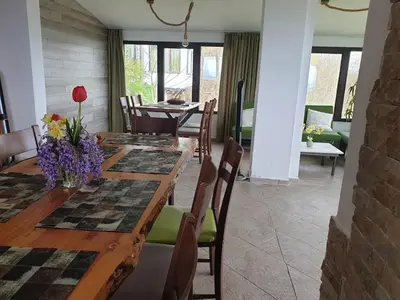 a dining room with a long table and chairs at Karadzhovata Kashta in Zlatograd