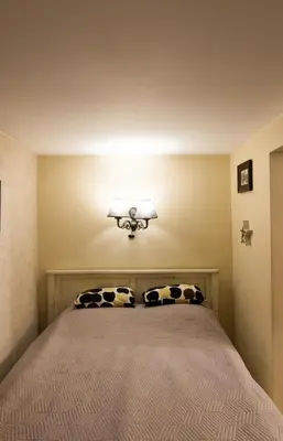 a bedroom with a bed with two pillows at Vintage Lozenets Apartment in Sofia