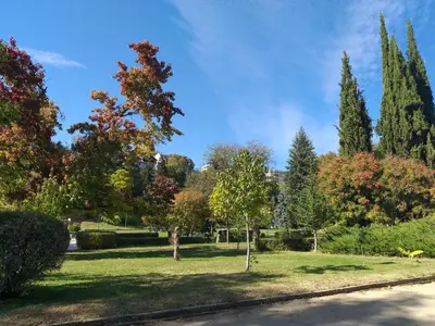 a park with trees and grass and a road at City Sandanski in Sandanski