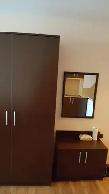 a bathroom with a black cabinet and a mirror at City Sandanski in Sandanski