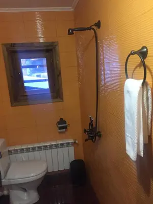 a bathroom with a toilet and a window at ЧОЛАКОВАТА КЪЩА in Koprivshtitsa