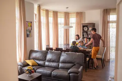 a group of people in a living room with a couch at KATERINA guest house in Kocherinovo