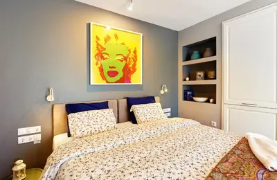 a bedroom with a bed and a painting on the wall at Stylish and High-end Designer Apartments in City Center in Sofia