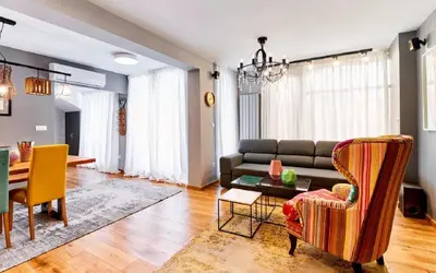 a living room with a couch and a table at Stylish and High-end Designer Apartments in City Center in Sofia