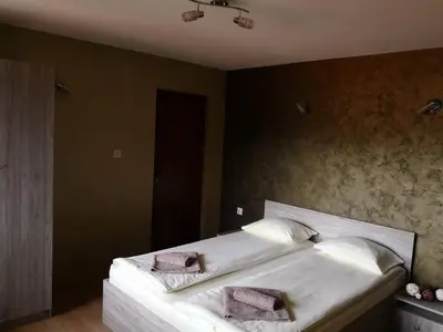 a bedroom with a large white bed with two pillows at Yurukovata kashta in Koprivshtitsa