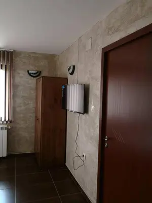 a room with a door and a lamp on the wall at Yurukovata kashta in Koprivshtitsa