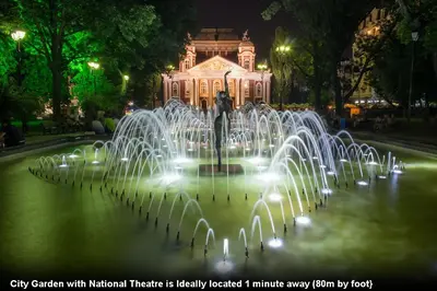 a fountain in a park with a building in the background at Interhost Guest rooms and apartments in Sofia