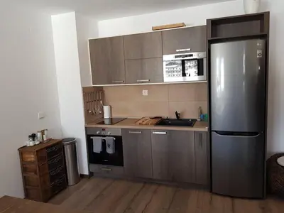 a kitchen with a large stainless steel refrigerator at VIP Apartment Stenata Complex in Pamporovo