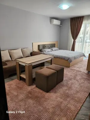 a living room with a bed and a coffee table at Studio Ivana in Sandanski
