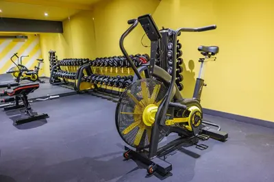 a gym with several exercise bikes in a room at Iglika Hotel & Villas Borovets in Borovets