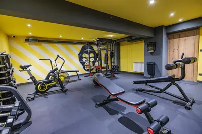 a gym with several exercise equipment in a room at Iglika Hotel & Villas Borovets in Borovets