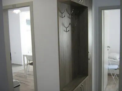 a wooden cabinet in a room with a mirror at Khan Krum House & Apartments for rent in Elin Pelin