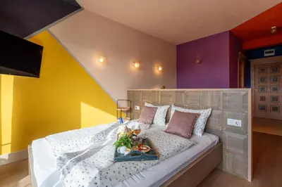 a bedroom with a bed with a tray of food on it at Boutique Hotel Casa Art in Oreshak