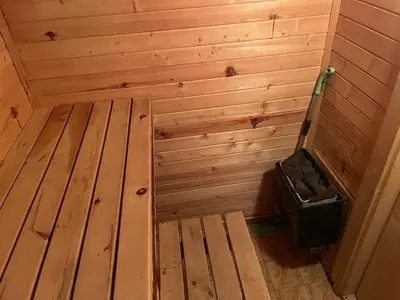 a wooden sauna with a trash can in the corner at Chalet Sofia in Borovets