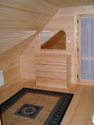 a wooden cabin with a large window and a rug at Chalet Sofia in Borovets