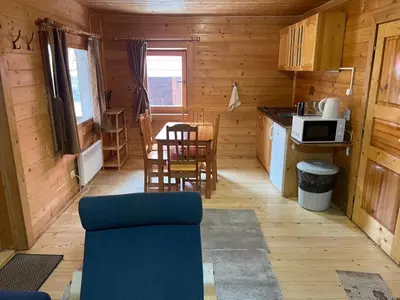 a kitchen with a table and chairs in a cabin at Chalet Sofia in Borovets