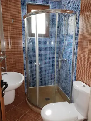 a bathroom with a shower and a toilet and a sink at Комплекс Рожена, хотел, хотелски комплекс Рожена in Rozhen