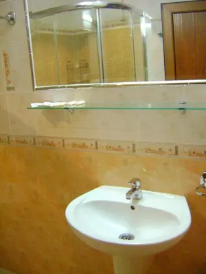 a bathroom with a sink and a mirror at Комплекс Рожена, хотел, хотелски комплекс Рожена in Rozhen