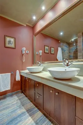 a bathroom with two sinks and a large mirror at Shiroka Laka Hotel in Shiroka Lŭka