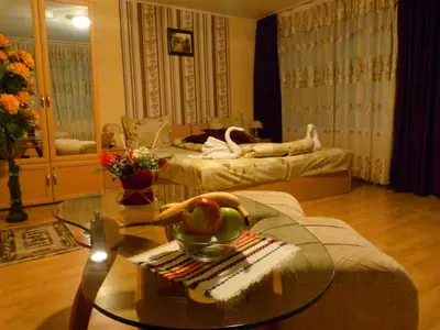 a living room with a glass table and two beds at Комплекс 