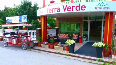a store front with a red cart outside of it at Комплекс 