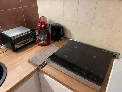 a red blender sitting on a counter in a kitchen at Top center 