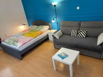 a living room with a couch and a bed at Top center 