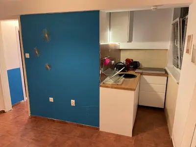 a blue door in a kitchen with a counter at Top center 
