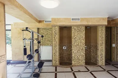 a bathroom with a shower with tiled walls at Family Hotel Hebar in Batak