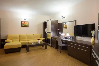 a living room with a couch and a table at Family Hotel Hebar in Batak