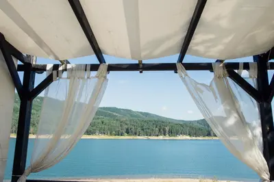 a view from the inside of a tent overlooking a lake at Family Hotel Hebar in Batak