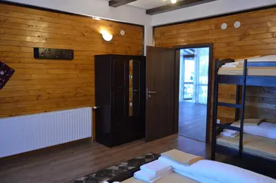 a room with bunk beds and a hallway at Ваканционно селище Ива in Sarnitsa