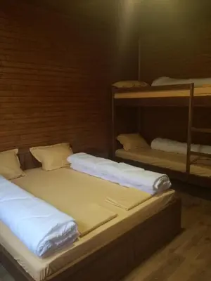two bunk beds sitting in a room with a light at Ваканционно селище Ива in Sarnitsa