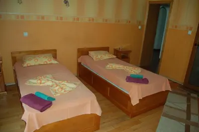 two beds in a room with towels on them at Kniaz Boris Hotel in Sofia