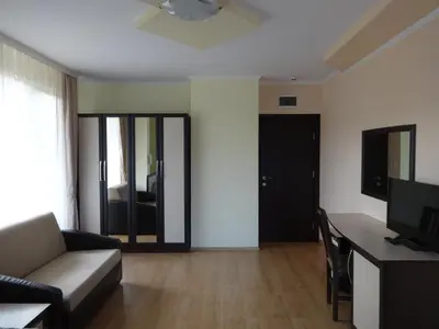 a living room with a couch and a table at Семеен хотел 