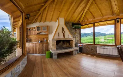 a living room with a fireplace in a house at Семеен хотел 
