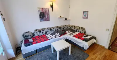 a living room with a couch and a table at Cozy Flat in Sofia