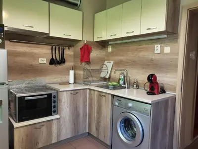 a kitchen with a sink and a washing machine at Cozy apartment in the heart of Sofia in Sofia