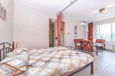 a bedroom with a bed and a table and chairs at Visit Sofia Macedonia Square Central Apartment by Flat Mаnager in Sofia