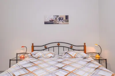 a bedroom with a bed with two lamps on it at Visit Sofia Macedonia Square Central Apartment by Flat Mаnager in Sofia