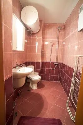 a bathroom with a toilet and a sink and a shower at Apartment Geo Milev in Plovdiv