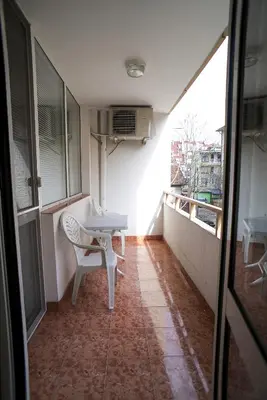 a balcony with a table and a chair in a room at Apartment Geo Milev in Plovdiv
